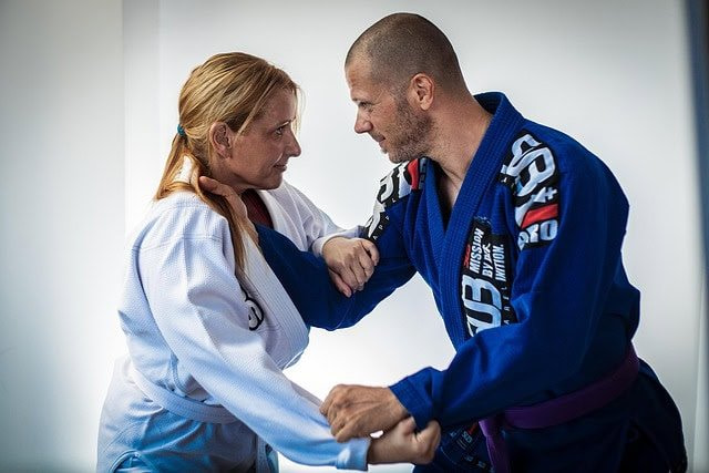 BJJ practitioner applying ground control techniques - leverage-based grappling system for neutralizing larger opponents BJJ practitioner applying ground control techniques - leverage-based grappling system for neutralizing larger opponents