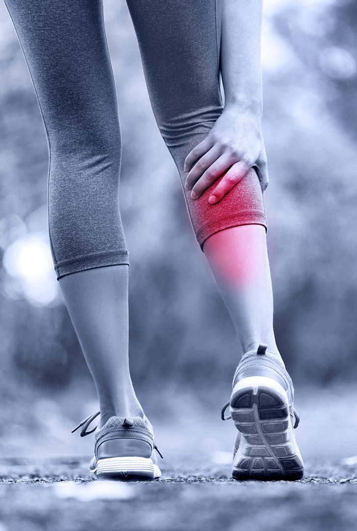 Calf Female Holding Calf Red Pain Woman holding her calf with the painful area shown in red, as in a gastrocnemius tear