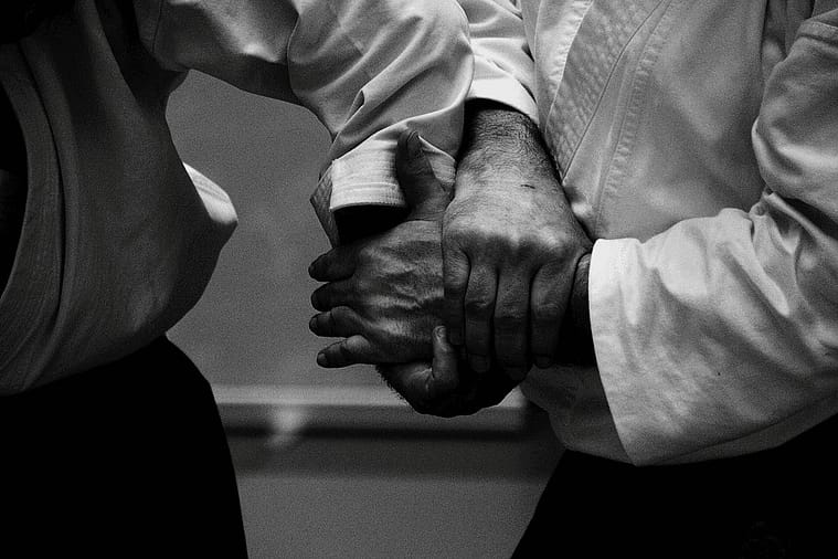 Two aikidokas engaged in hand lock Close-up of two hands in an aikido wrist grip