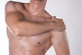 Shoulder Athlete Holding Shoulder II Shoulder Injuries | Fighting Arts Health Lab