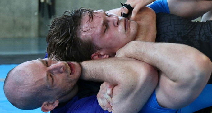 BJJ athlete demonstrating rear naked choke BJJ athlete demonstrating rear naked choke