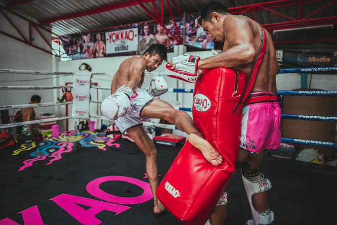 Muay thai fighter demonstrating a low kick Muay thai fighter demonstrating a low kick