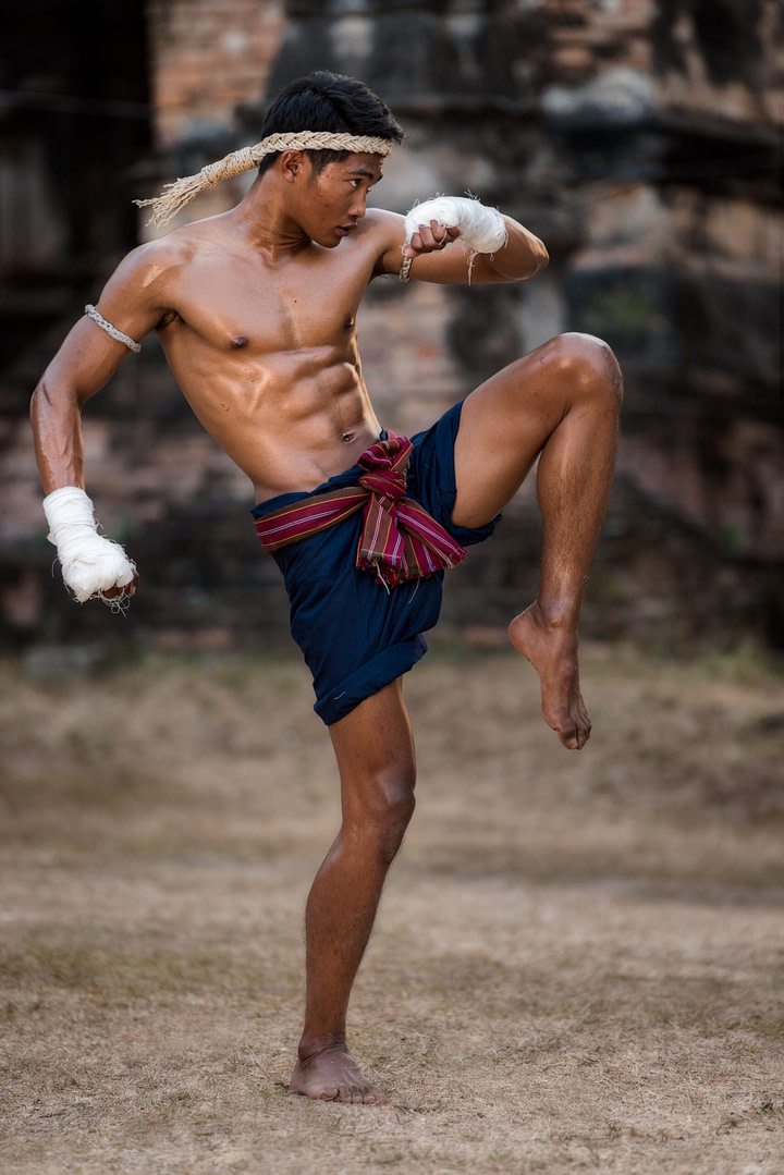 Muay Thai fighter demonstrating knee strike technique Muay Thai fighter demonstrating knee strike technique