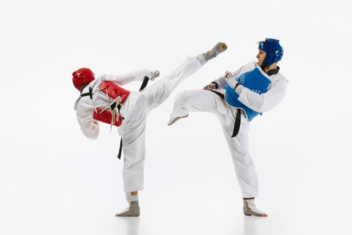 Taekwondo student performing high roundhouse kick with perfect form Taekwondo student performing high roundhouse kick with perfect form