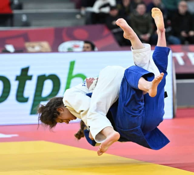 Judo practitioner executing ippon throw technique - using leverage and momentum to control opponents Judo practitioner executing ippon throw technique - using leverage and momentum to control opponents